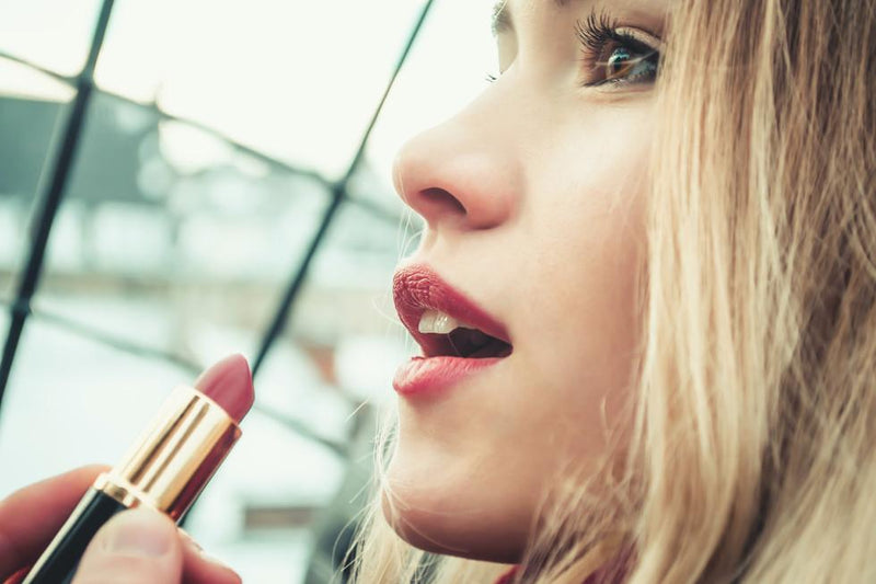 Model applying lipstick